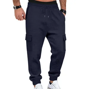 Close-up of navy waffle knit cargo joggers with drawstring waist and side pockets
