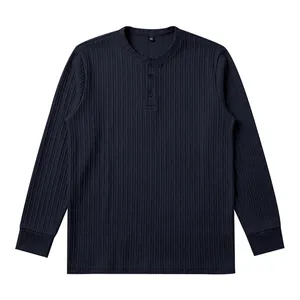 Close-up view of the vertical ribbed texture and button placket on a navy Henley shirt