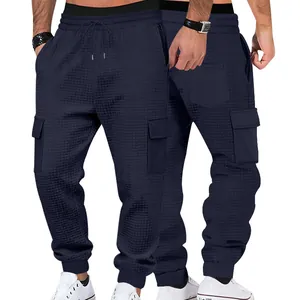Detail view showing front and back of navy blue waffle knit cargo joggers for men.