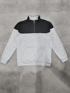 Close-up of men's quarter-zip colorblock sweatshirt with quilted chest pattern