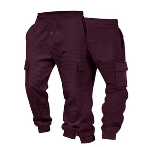 Detailed view of men's waffle cargo joggers with drawstring waist and pockets