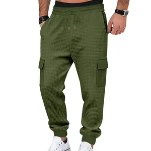 Detailed view of men's olive green waffle knit cargo joggers with drawstring elastic waist