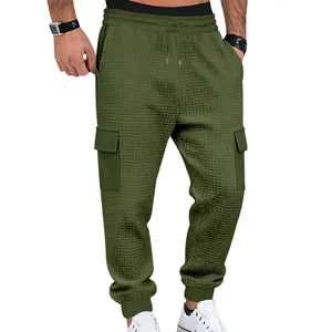 Detailed view of army green waffle textured cargo joggers with side flap pockets