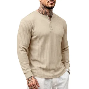Detail view of the vertical ribbed texture on a men's long sleeve beige Henley shirt.