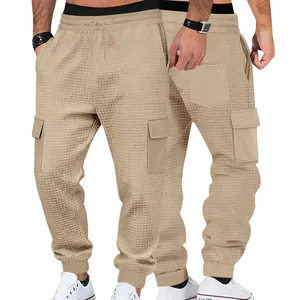 Detailed view of men's khaki waffle-knit cargo joggers with functional side pockets.