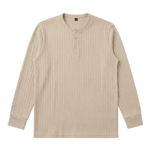 Detailed macro shot of men's beige vertical ribbed Henley long sleeve knit T-shirt