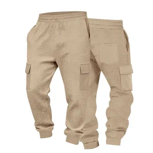 Close-up of men's waffle knit cargo joggers featuring side pockets and drawstring waist.
