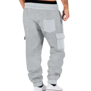 Back view of light grey men's waffle knit cargo joggers featuring multiple pockets