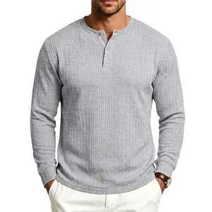 Detail view of grey long-sleeved Henley shirt with vertical texture and buttons