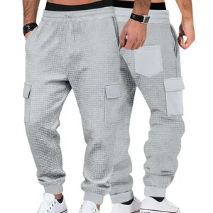 Detailed front and back view of men's gray waffle knit cargo joggers with pockets.
