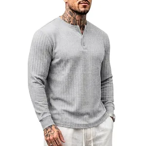Detail of gray men's long-sleeve Henley shirt featuring vertical ribbed texture.