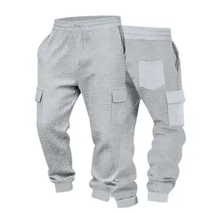 Macro detail of men's grey waffle knit cargo joggers showing fabric texture and pockets