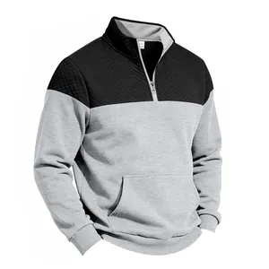 Detail of men's quarter-zip sweatshirt with quilted shoulders and kangaroo pocket