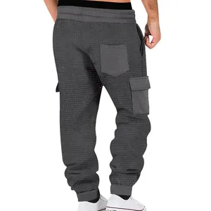 Detailed back view of men's dark grey waffle knit cargo joggers with multi-pocket design