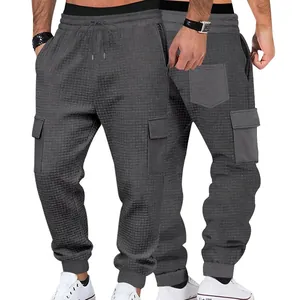 Detailed view of men's gray waffle knit cargo joggers with adjustable drawstring waist.