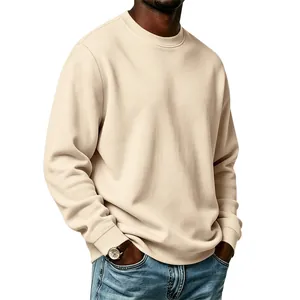 Detail shot of the soft fleece fabric and ribbed cuffs on an apricot crewneck sweatshirt