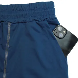 Close-up of side pocket on blue men's athletic shorts showing smartphone storage.