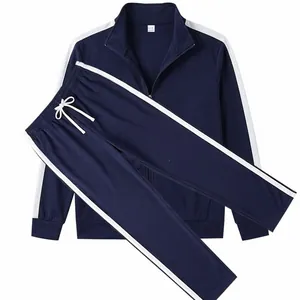 Close-up of navy blue tracksuit set with white side stripes and stand collar zip jacket