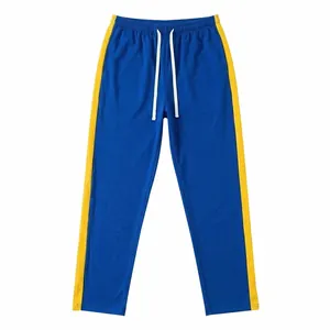 Men's casual blue sports track pants featuring bold yellow side stripes and white drawstring