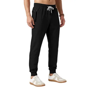 Detailed view of men's black drawstring joggers with side zipper pockets and ribbed cuffs
