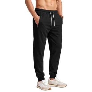 Close-up of black men's joggers with drawstring waist and functional zipper pockets