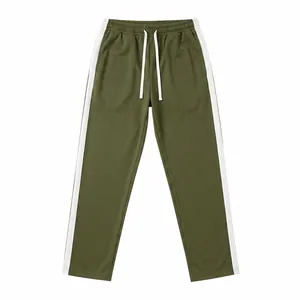 Detailed view of men's olive green sweatpants with white side stripes and drawstring.