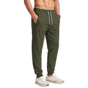 Men's olive green joggers featuring an elastic waist, drawstring, and side zipper pockets.