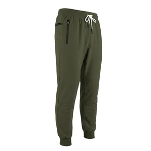 Detail view of men's olive green joggers with white drawstring and zipper pocket