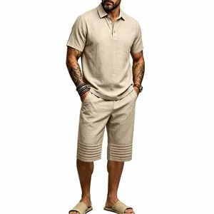 Full body view of a men's beige cotton linen polo and shorts set with unique pleated hem detail.