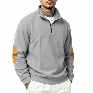 Detail view of grey ribbed half-zip sweatshirt featuring decorative brown elbow patches