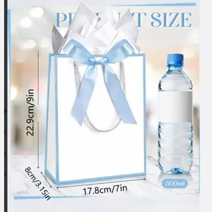 Size illustration of white gift bag with light blue bow and decorative tissue paper