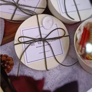 Detail view of round wedding candy box with ribbon and minimalist card