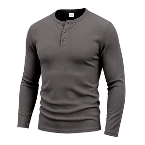 Close-up detail of a grey waffle knit henley shirt featuring a three-button placket