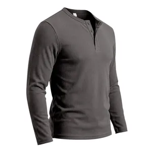 Detail of waffle knit texture and Henley button neck on dark grey long sleeve shirt