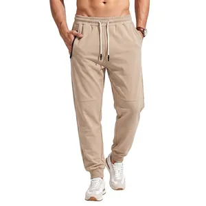 Close-up detail of men's beige joggers featuring a drawstring waist and secure side zipper pocket
