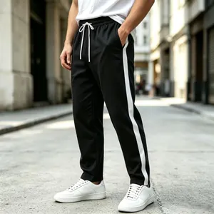 Detailed view of men's black straight-leg sweatpants with contrast white side stripe