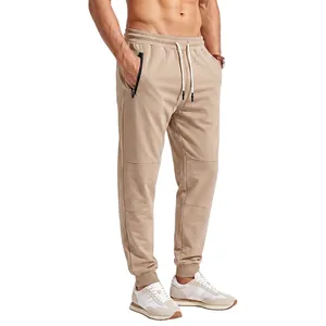 Detailed view of men's khaki jogger pants featuring drawstring waist and secure zipper pockets.
