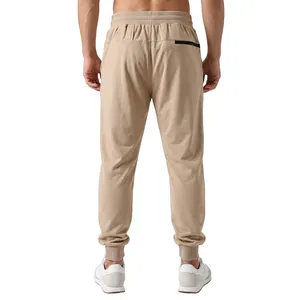 Detailed back view of men's beige joggers featuring elastic waist and ribbed cuffs