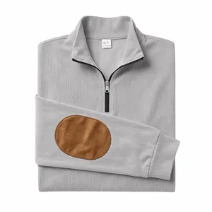 Detail of grey ribbed quarter-zip pullover featuring contrast brown elbow patch.