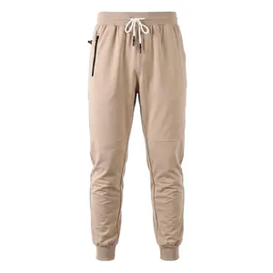 Detail view of men's tan joggers featuring a side zip pocket and drawstring waist.