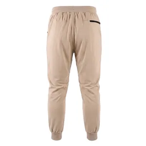 Detailed rear view of beige men's jogging pants with elastic waist and back zipper pocket