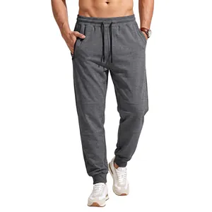 Mens grey drawstring joggers featuring an elastic waist and zippered side pockets for sport