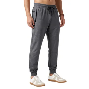 Close-up of men's grey jogger pants with side zipper pockets and drawstring waist.