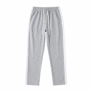 Detail view of grey sweatpants with white side stripes and adjustable drawstring waist