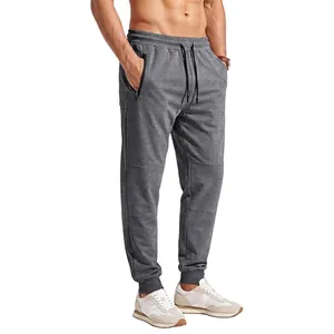 Men's grey joggers with elastic drawstring waist and side zipper pockets for sports