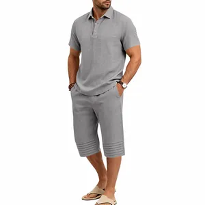 Full body view of a men's grey cotton linen two-piece set with a polo shirt and cropped pants.