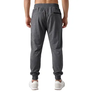 Detail back view of men's dark grey jogger pants with elastic waist and zipper pocket