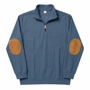 Close-up of blue ribbed sweatshirt featuring half-zip collar and brown elbow patches