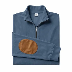 Macro view of blue ribbed sweatshirt featuring half-zip collar and brown suede elbow patches