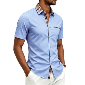 Detailed view of light blue men's shirt with stylish checkered contrast collar and pocket detail.